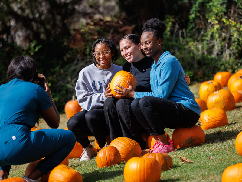 School of Dentistry first-year students, from left, Nikirah Bridges, Kaylee Routh and Jayla Holloway smile for a photo at the UMMC Associated Student Body pumpkin patch.
